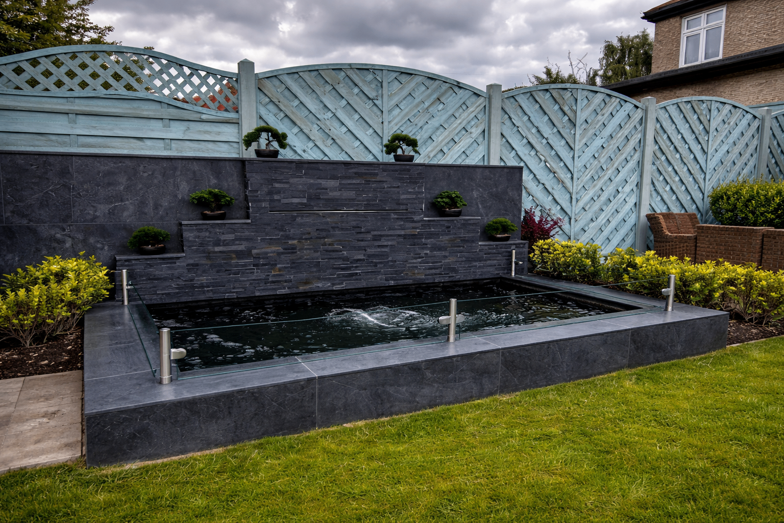 Stainless steel posts and glass panels fitted to a real customer koi pond